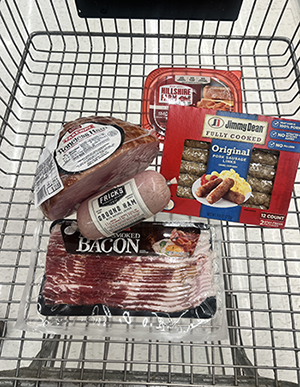 Grocery cart with pork products.